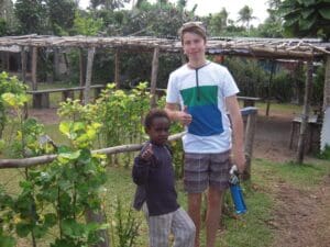 A student and local child share a connection, honouring global citizenship and Kindlehills spirit of cross-cultural community.
