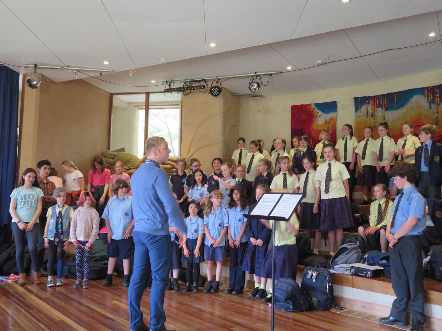 Diverse primary students unite, fostering a spirit of community and shared purpose through combined musical performance.