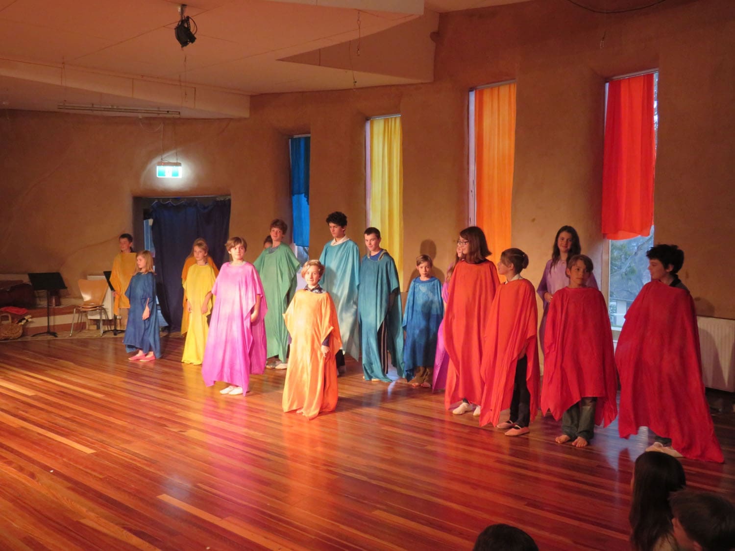 Kindlehill students in colourful silken robes perform at the Summer Soiree, celebrating artistic expression and shared community rhythm.