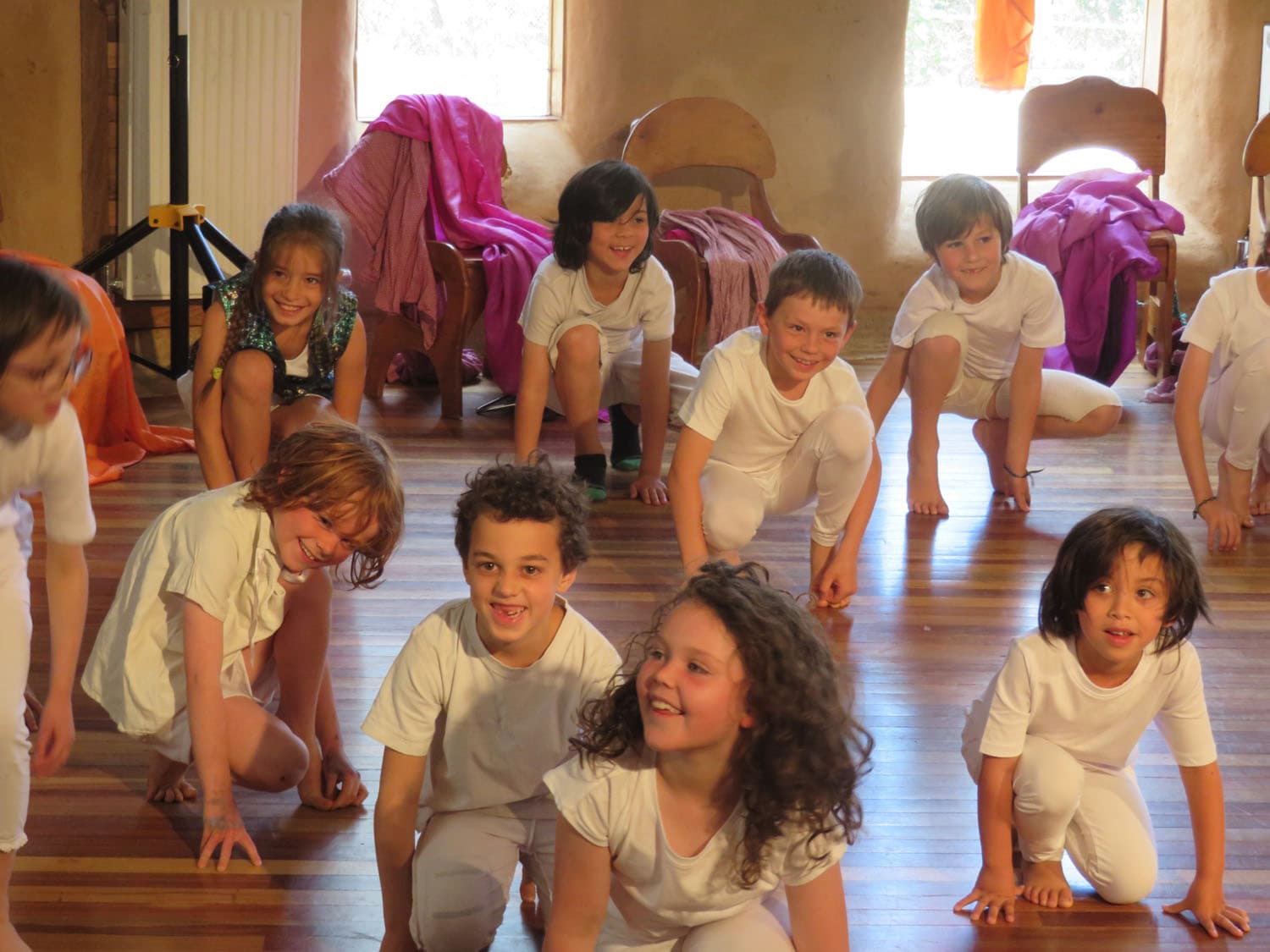 Class 1/2 students joyfully perform their seasonal play, embodying Kindlehills creative spirit and deep connection to natural rhythms.