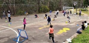 Students engage in cooperative games at Kindlehill, building community and resilience within the surrounding Blue Mountains bushland.