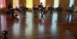 The Kindlehill jazz ensemble performs together, embodying artistic expression, community connection, and shared purpose through collaborative music.