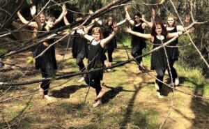 Aboriginal girls perform the Burudjara Bija butterfly dance, practising Darug culture and connecting with Country in the bushland.