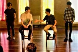 Collaborative students express artistic rhythms and social connection, awakening creative beauty through an immersive musical performance in a hall.