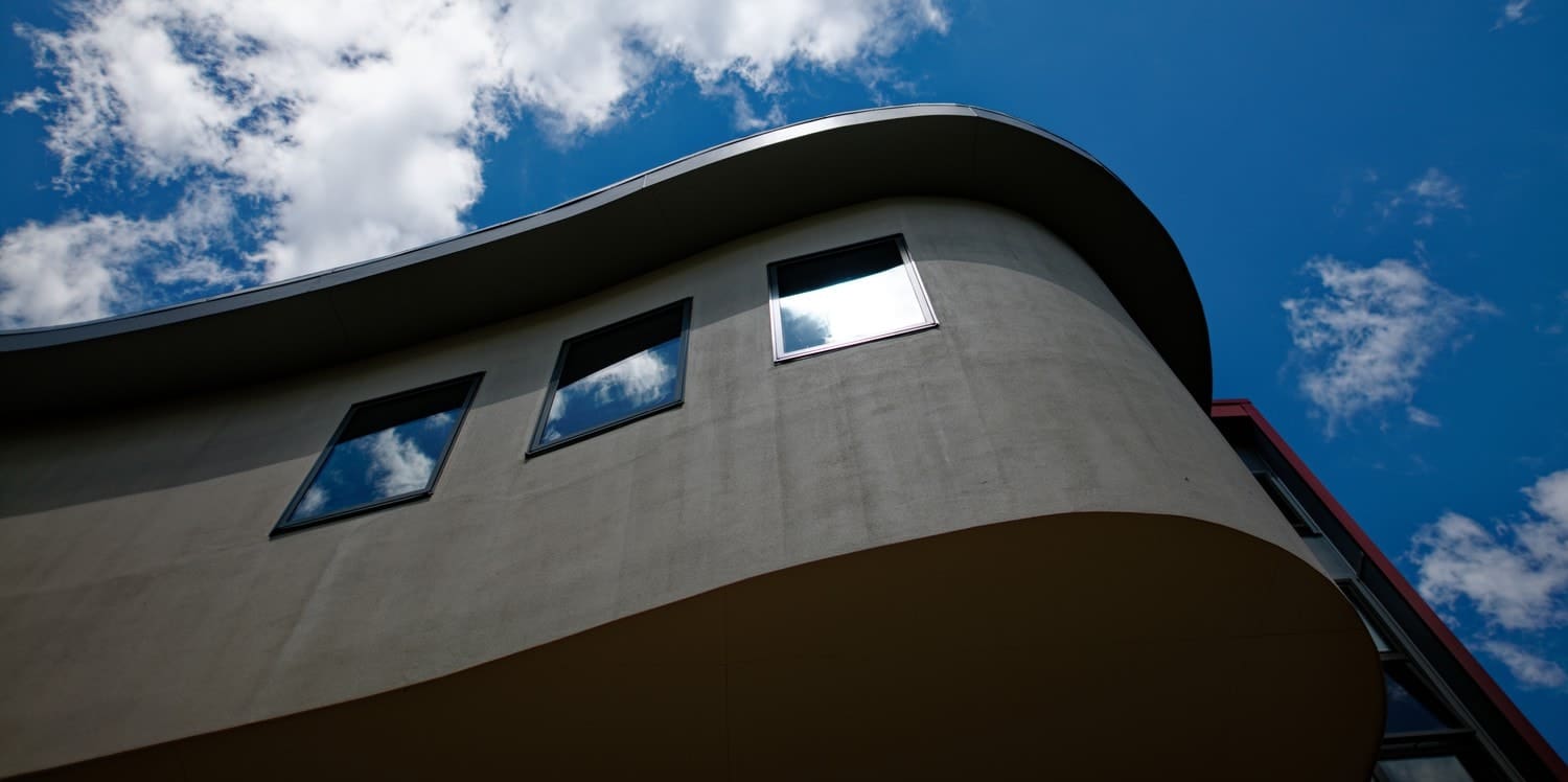 Curved Kindlehill architecture reflects the vast sky, grounding history and learning within the timeless rhythm of Country.