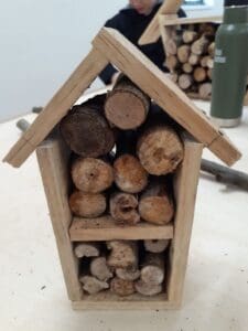 Hand-built insect houses from salvaged timber foster earth-centred learning and a deep connection with the living world.