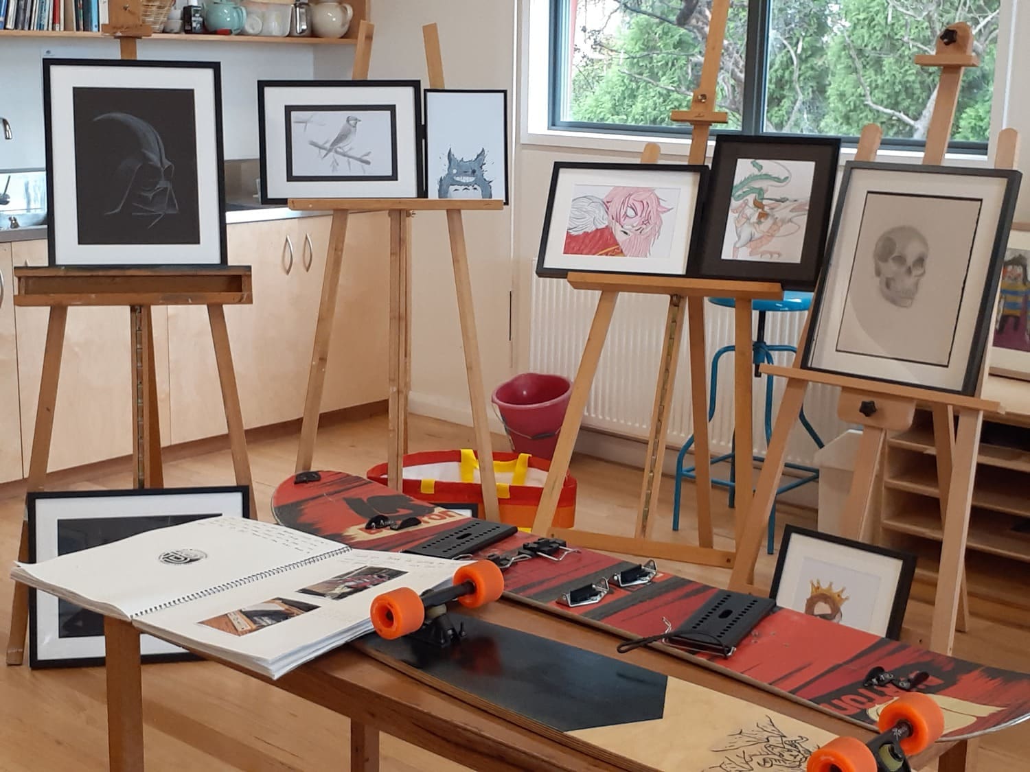 Kindlehill Big Project presentations celebrate individual creative journeys through diverse artistic sketches and a handcrafted longboard.