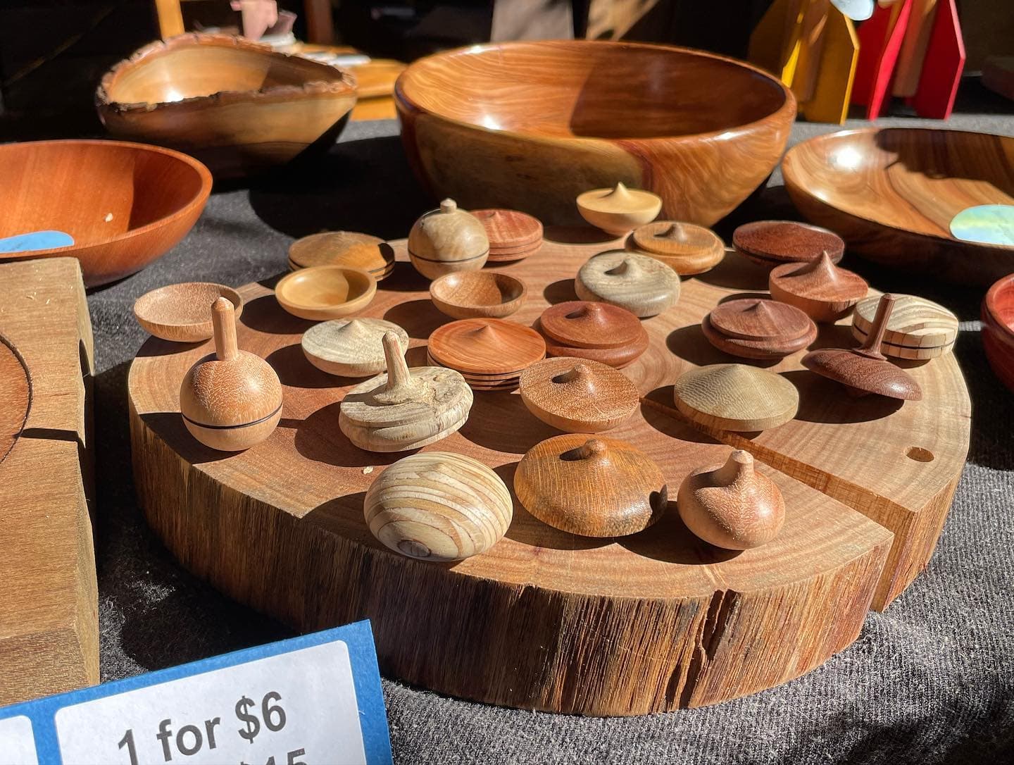 Hand-carved wooden tops and bowls showcase heart-led handiwork and community spirit at Kindlehills vibrant artisan fair.