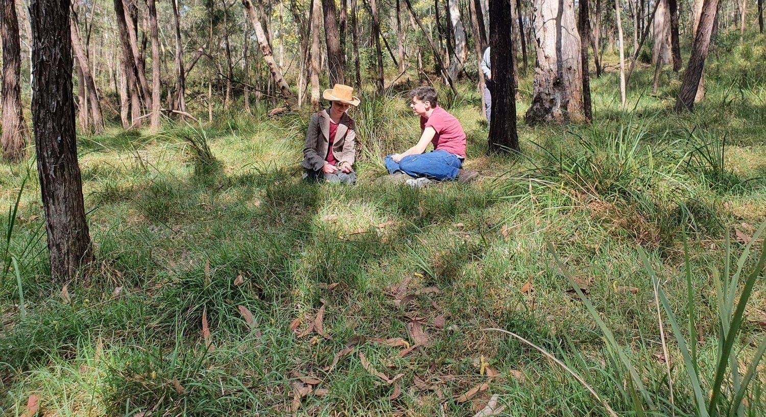 Students sit quietly on Country, connecting with the ancient stories and rhythm of the wild Yarramundi bushland.