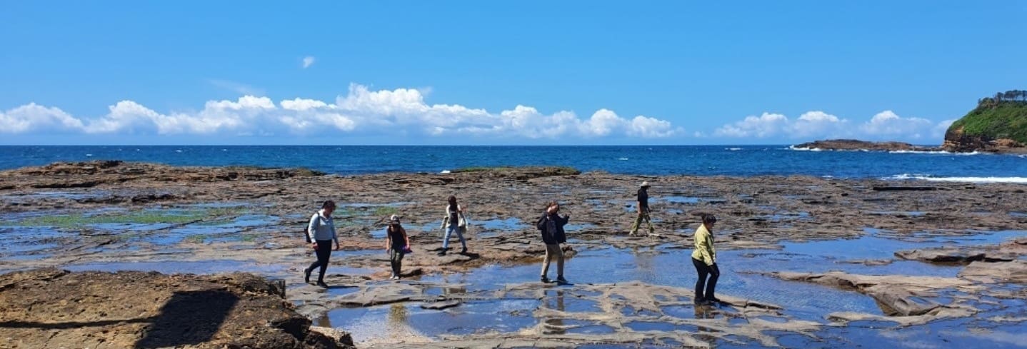 Kindlehill students traverse coastal rock platforms, fostering transformation and curiosity through immersive connection to the natural world.
