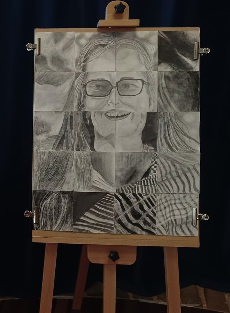 Collaborative charcoal patchwork portrait honours Pippita, reflecting Kindlehills spirit of community and shared artistic expression.