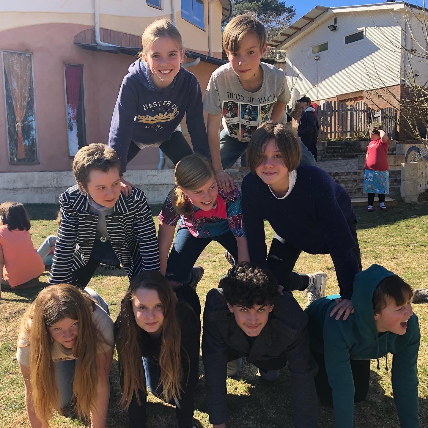 Students form a cooperative human pyramid, showcasing the warm spirit of community and connection at Kindlehill.