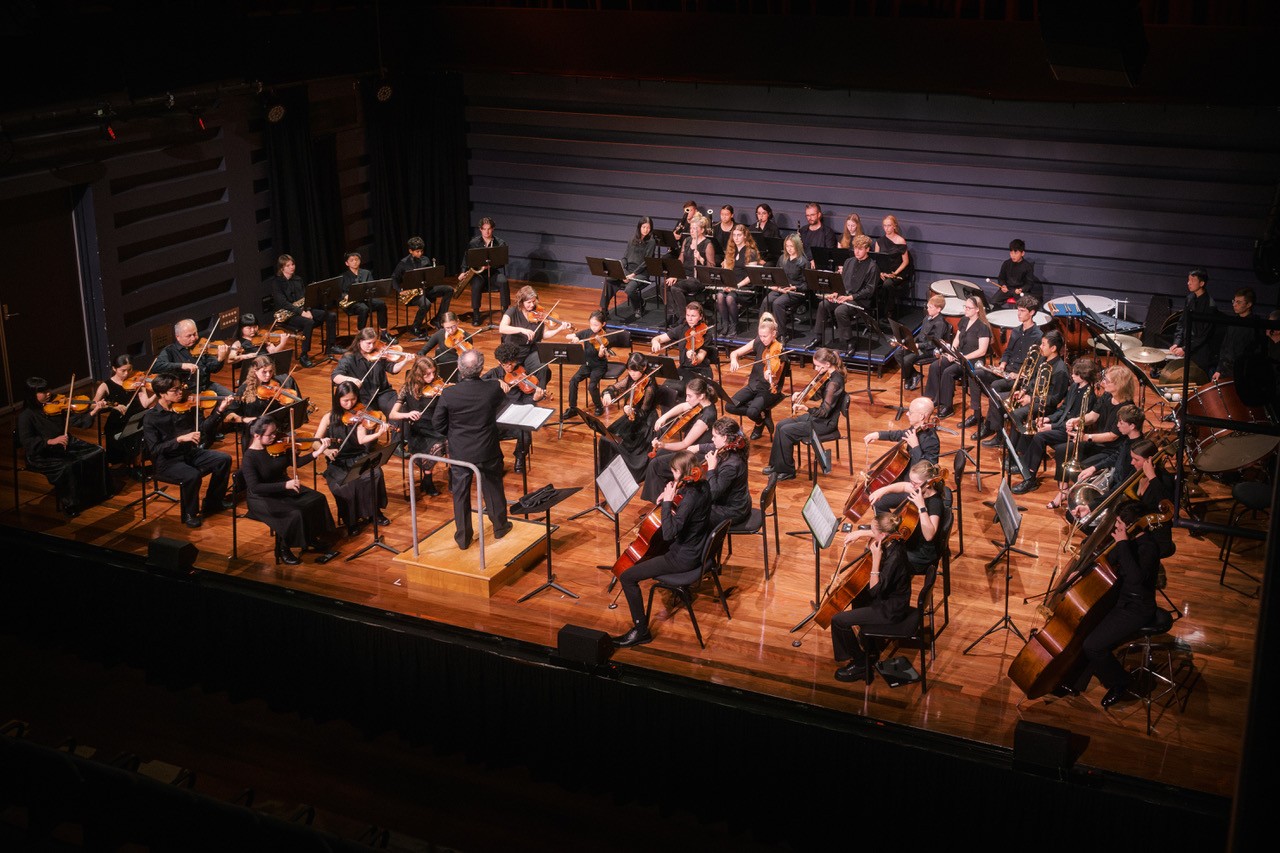 Kindlehill students perform within a youth orchestra, cultivating artistic expression and communal connection through shared musical purpose.