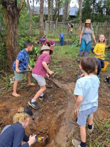 Kindlehill students and educators work together digging soil, connecting to Country through purposeful, earth-centred community action.