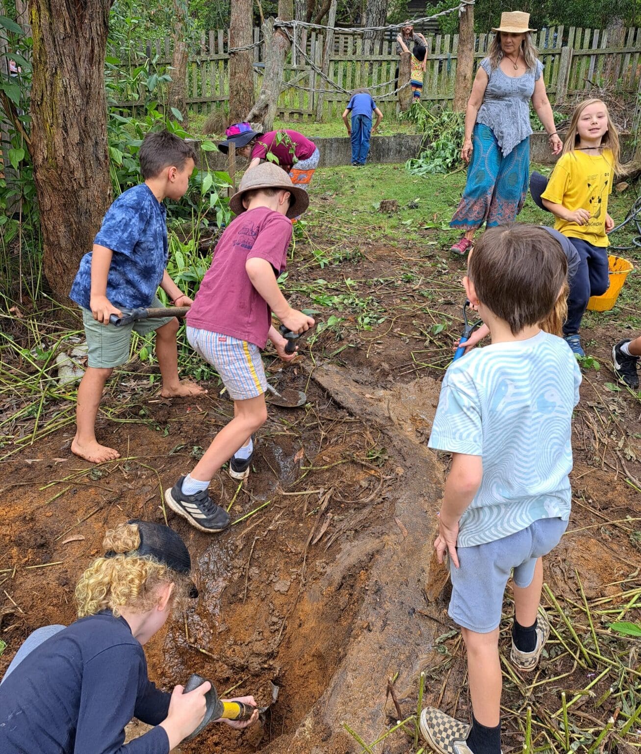 Kindlehill students and educators work together digging soil, connecting to Country through purposeful, earth-centred community action.