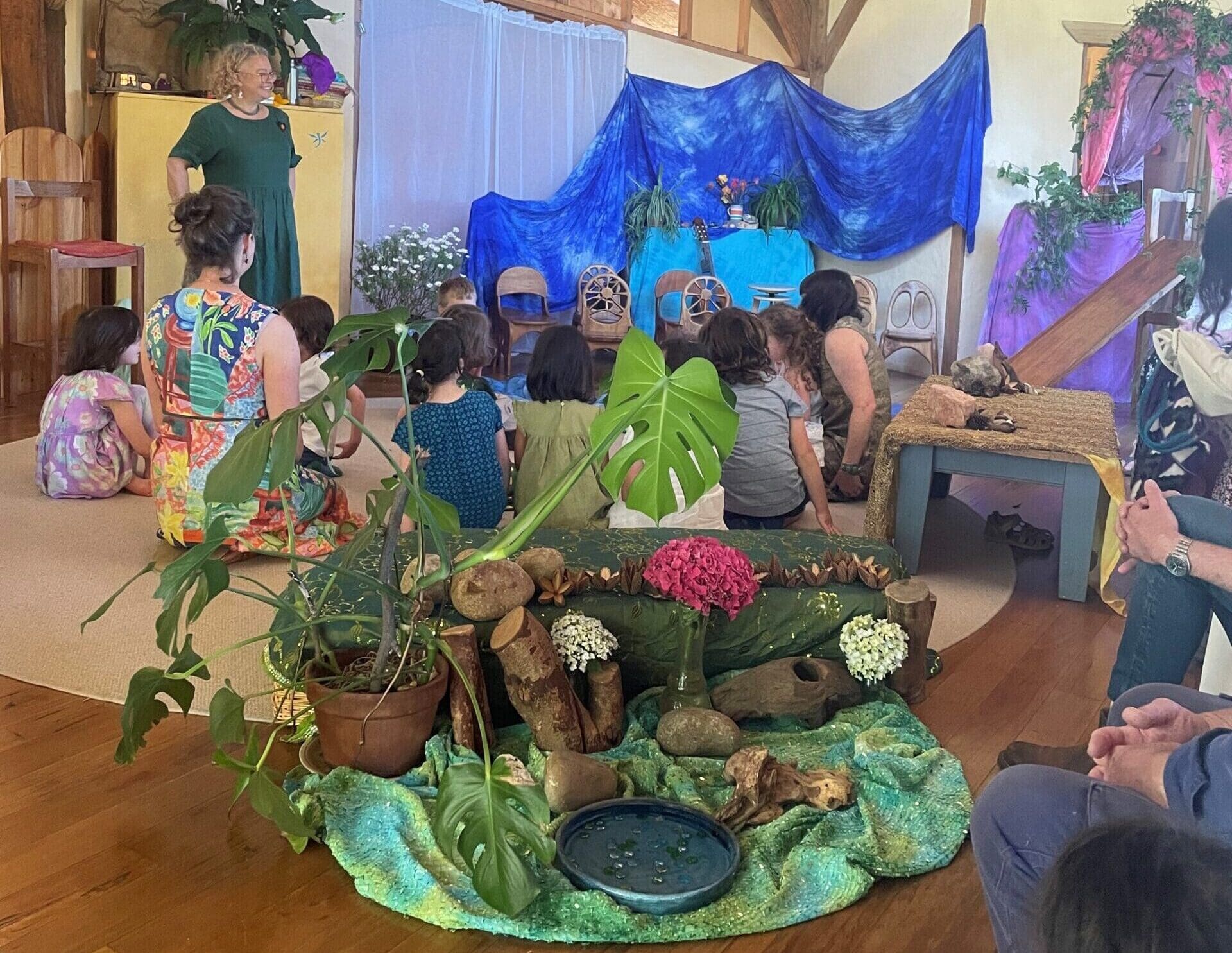 Kindlehill families gather for storytelling, awakening imagination through a nature-centred community rhythm and shared sense of wonder.