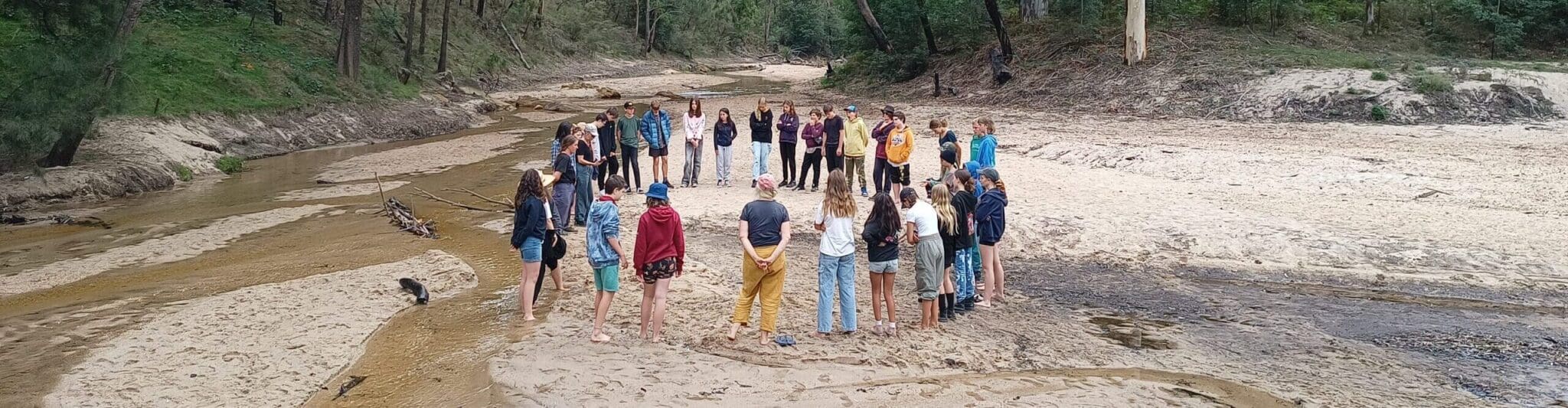 Kindlehill students gather in a circle on Country, honouring the seasonal rhythm and fostering a shared sense of belonging.