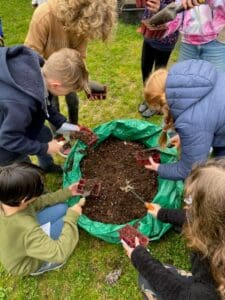 Kindlehill students collaboratively garden, fostering earth-centred connections and a shared spirit of contribution to their community.