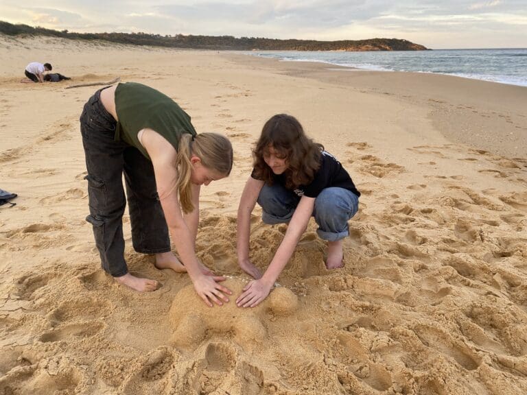 Kindlehill students collaborate on a beach sculpture, connecting with Country through tactile creativity and a shared sense of community.