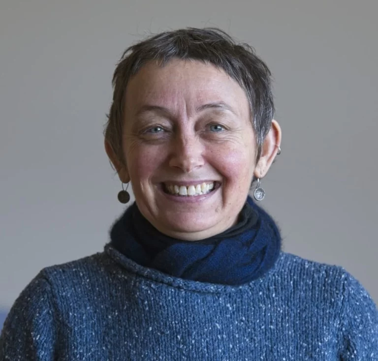 A smiling woman embodies the warm Kindlehill spirit and the creative vision behind the schools evolutionary building projects.