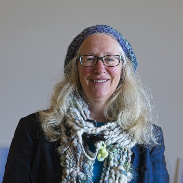 A Kindlehill educator wearing hand-spun wool, celebrating artistic expression and the warm spirit of this vibrant Steiner community.