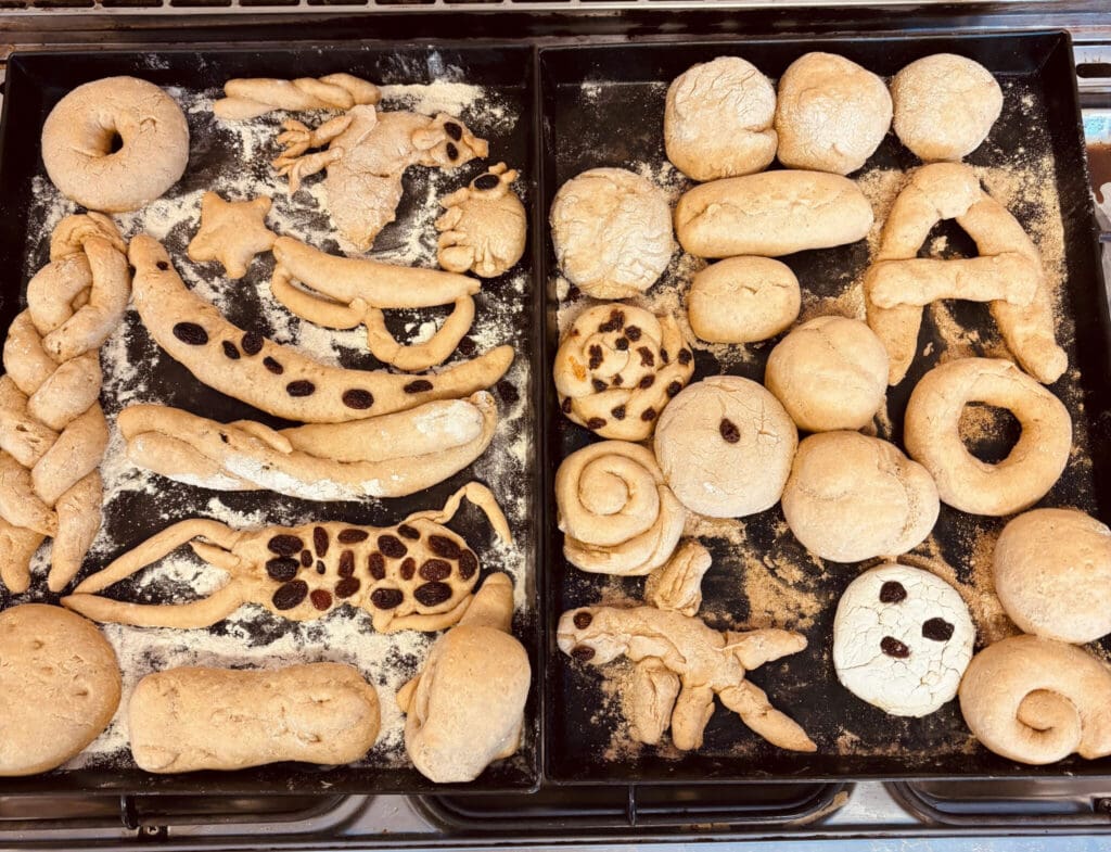 Hand-sculpted dough shapes honour individual imagination within the shared rhythm of community work and collective nourishment.