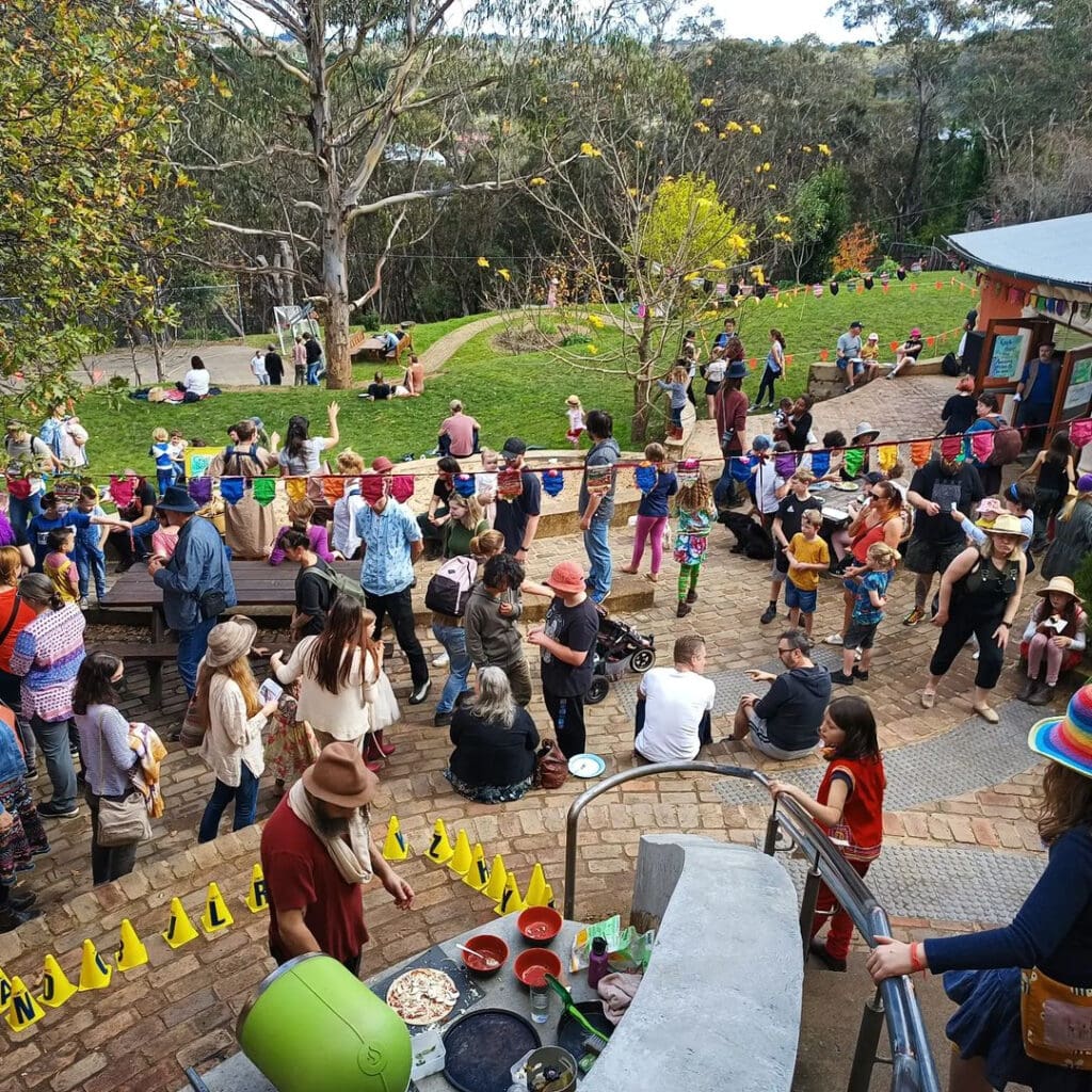 Kindlehill families gather in a vibrant bushland courtyard, building a village of connection and shared belonging.