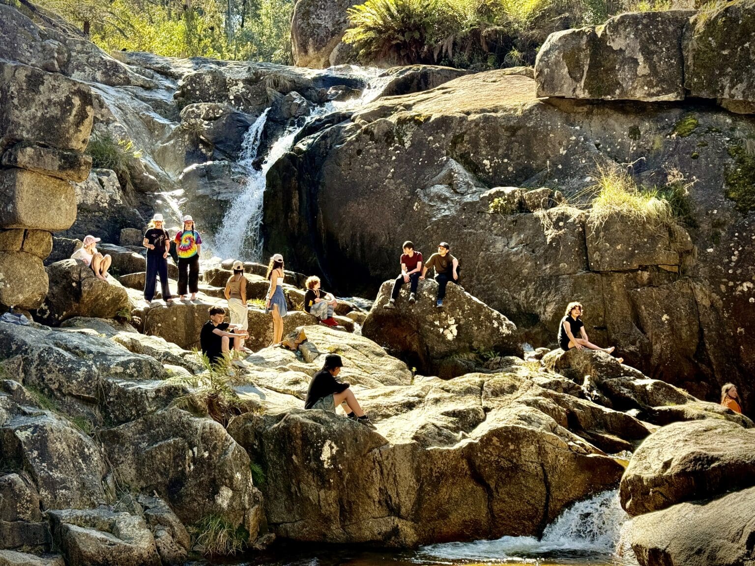 Kindlehill students connect with the wildness of Country and community beside a cascading Blue Mountains waterfall.