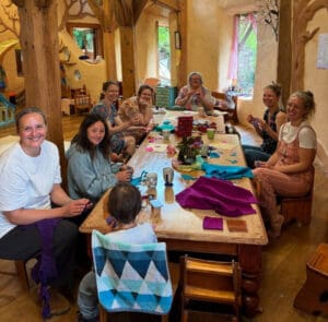 Community members craft together inside the hand-sculpted, earth-built kindergarten, honouring a shared sense of belonging and social collaboration.